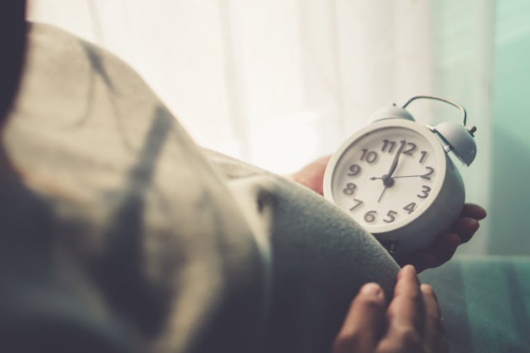 Pregnant belly and ticking clock in mom’s hand. “nPregnant people are watching the clock. To wait for his children