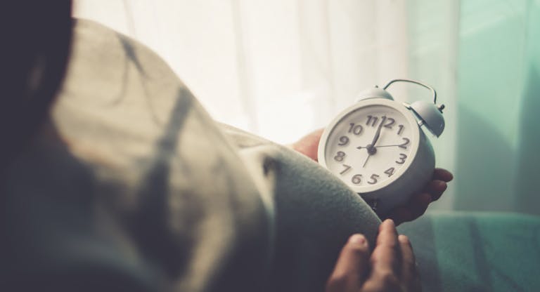 Pregnant belly and ticking clock in mom’s hand. “nPregnant people are watching the clock. To wait for his children