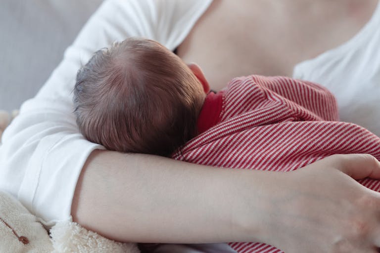 Mom breastfeeding a baby boy