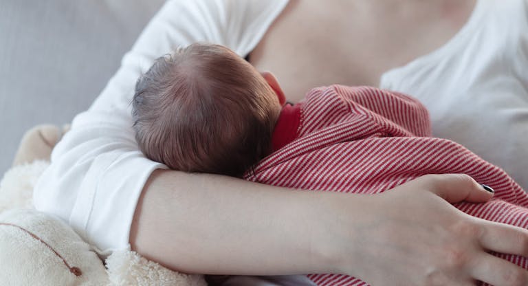 Mom breastfeeding a baby boy
