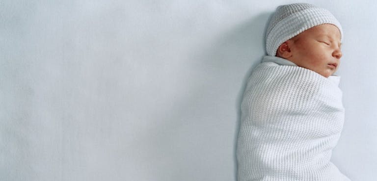 Newborn baby boy wrapped in blanket