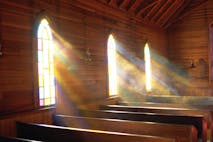 Light streaming through arched windows of church