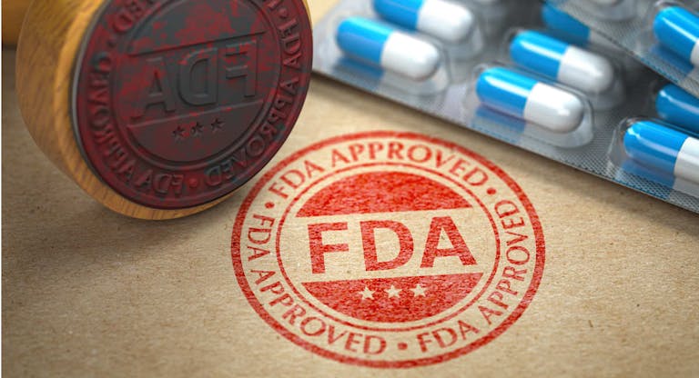FDA approved  concept. Rubber stamp with FDA and pills on craft paper.