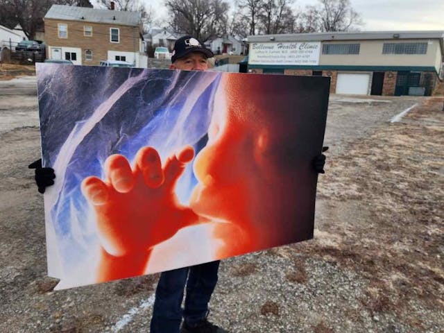 A supporter of the effort to see abortion outlawed in Bellevue, Nebraska stands with a pro-life sign outside of the abortion facility in Bellevue, Nebraska (Photo: Mark Lee Dickson) A supporter of the effort to see abortion outlawed in Bellevue, Nebraska stands with a pro-life sign outside of the abortion facility in Bellevue, Nebraska (Photo: Mark Lee Dickson)