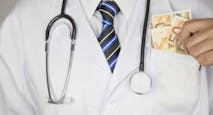 Greedy doctor squeezing money. Medical concept