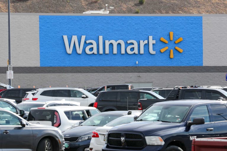 A Walmart logo seen from the parking lot of its store in