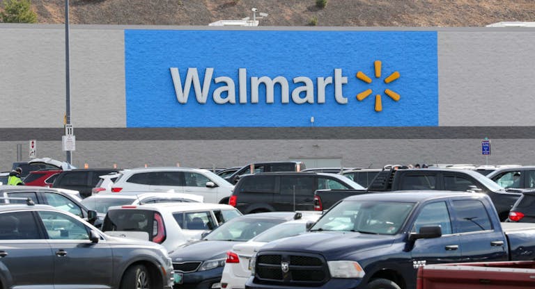 A Walmart logo seen from the parking lot of its store in