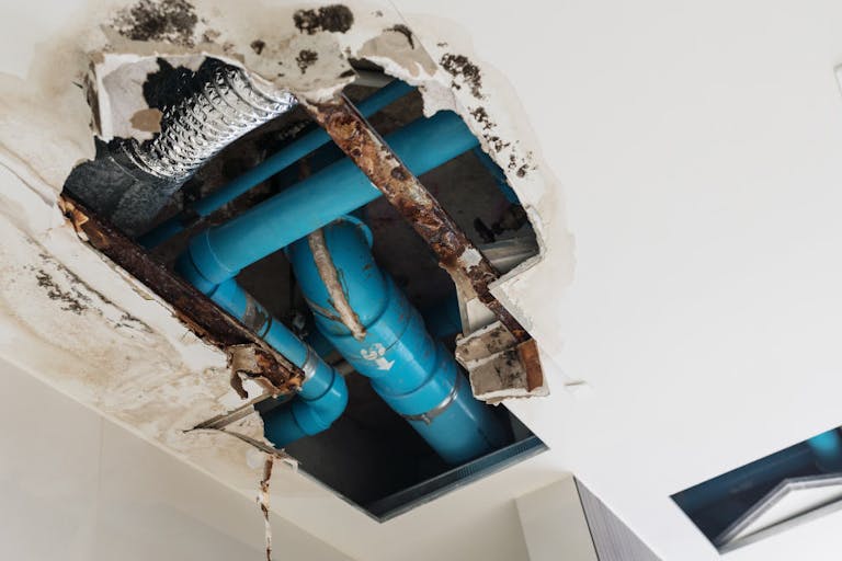 Damage home ceiling in restroom, water leak out from piping system make ceiling damaged