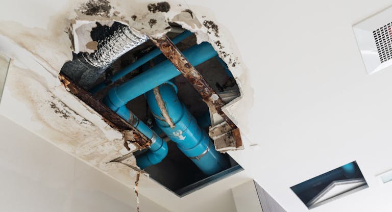 Damage home ceiling in restroom, water leak out from piping system make ceiling damaged