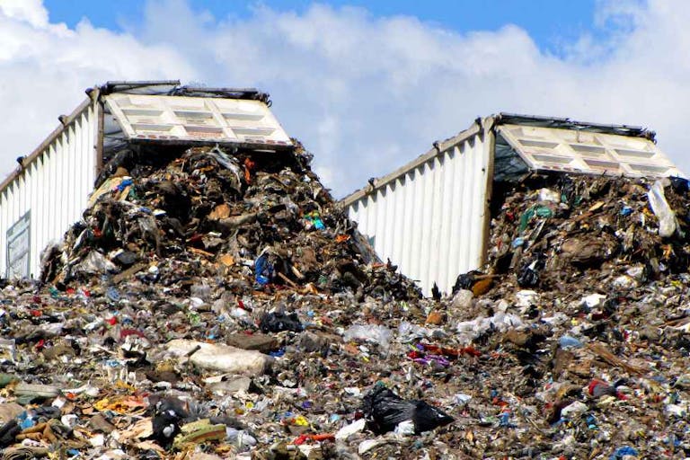 Two dump trucks at landfill