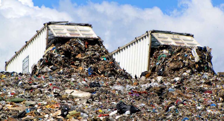 Two dump trucks at landfill