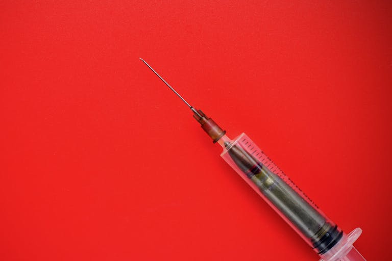 Photo: Iuri Gagarin/Getty Images Bullet in a disposable syringe on a red background