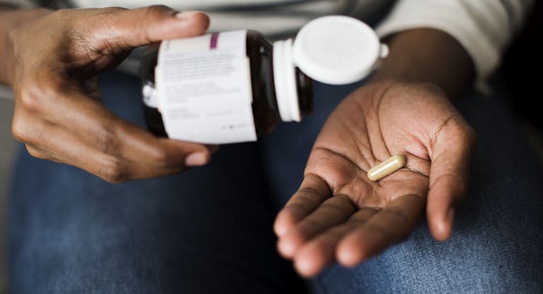 Woman taking pills for her health
