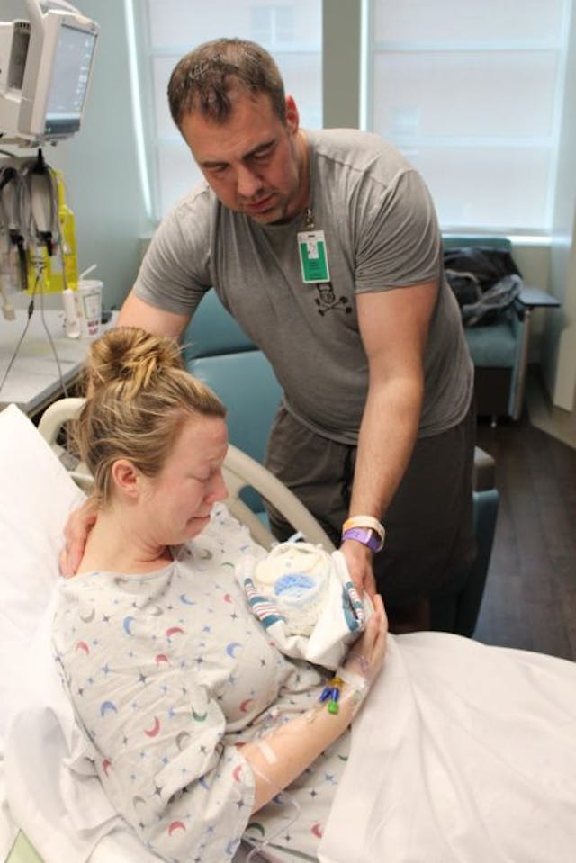 Shannon holds baby Spencer in his cradle from Bridget’s Cradles. Shannon and her husband also received a cradle when they lost their son Grady. ⒸAshley Opliger ‘Knit in your mother’s womb’: Bridget’s Cradles brings comfort to families with stillborn babies image
