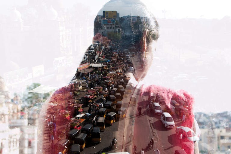 double exposure of a woman and Indian cityscape