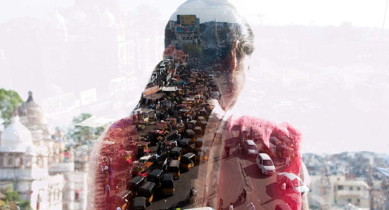 double exposure of a woman and Indian cityscape