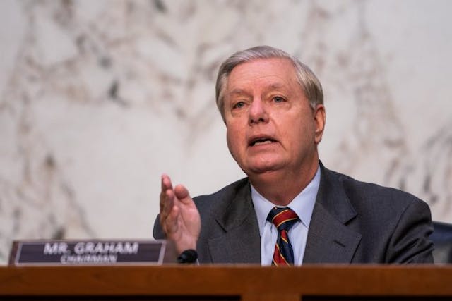 WASHINGTON, DC – OCTOBER 13: Lindsey Graham (R-SC) questions Supreme Court nominee Judge Amy Coney Barrett during the Senate Judiciary Committee on the second day of Amy Coney Barrett’s Supreme Court confirmation hearing on Capitol Hill on October 13, 2020 in Washington, DC. Barrett was nominated by President Donald Trump to fill the vacancy left by Justice Ruth Bader Ginsburg who passed away in September. (Photo by Demetrius Freeman – Pool/Getty Images) Judge Amy Coney Barrett grilled on Roe v. Wade during second day of Senate hearings image