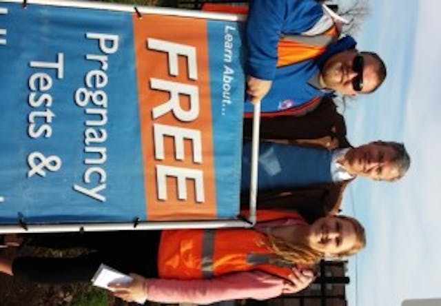 Brad, Patrick Burns, and Melissa DeRocher offering free pregnancy tests. Brad, Patrick Burns, and Melissa DeRocher offering free pregnancy tests