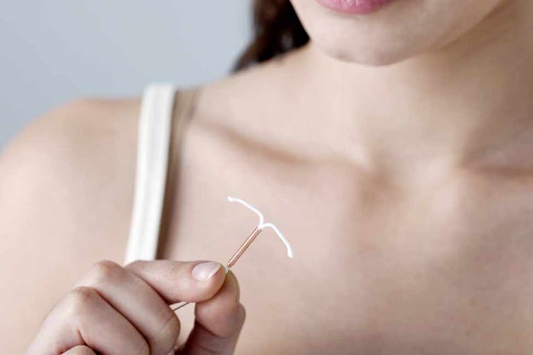IUD-birth-control-woman-holding