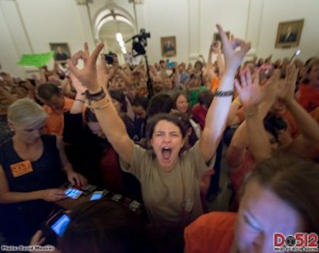 A pro-choice advocate acts out during debates over HB2 legislation in Texas. Abortion supporters had to later be forcibly removed from the floor viewing area after disrupting the legislative session with yelling. A pro-choice advocate acts out during debates over HB2 legislation in Texas.