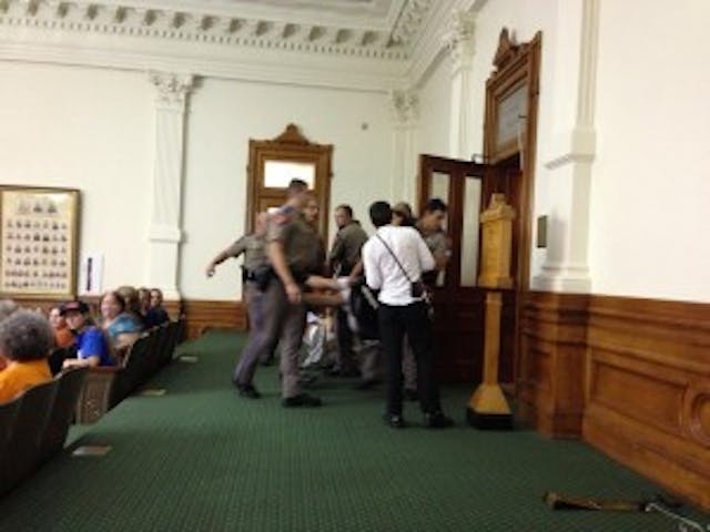 A pro-choice protestor is forcibly removed from the gallery during HB2 proceedings. Photo by Melissa Conway, provided by Texas Right to Life. A protestor is forcibly removed from the gallery during HB2 proceedings. Photo by Melissa Conway, provided by Texas Right to Life.