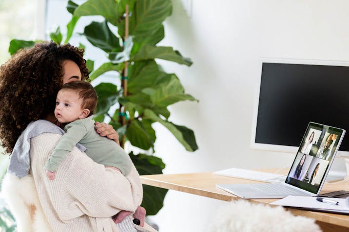 Mother talks with colleagues virtually while caring for her son