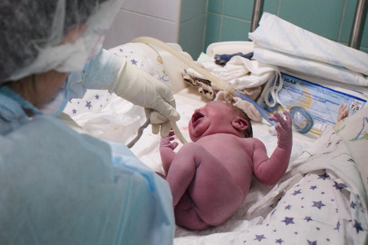 Photo by Anastasia Vlasova/Getty Images KYIV, UKRAINE - MARCH 30: A doctor and a nurse inspect a newborn boy in the maternity hospital on March 30, 2022 in Kyiv area, Ukraine. An estimated half of greater Kyiv's 3.5 million people have fled since the start of Russia's invasion, the capital's mayor said earlier this month.