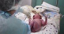KYIV, UKRAINE - MARCH 30: A doctor and a nurse inspect a newborn boy in the maternity hospital on March 30, 2022 in Kyiv area, Ukraine. An estimated half of greater Kyiv's 3.5 million people have fled since the start of Russia's invasion, the capital's mayor said earlier this month.