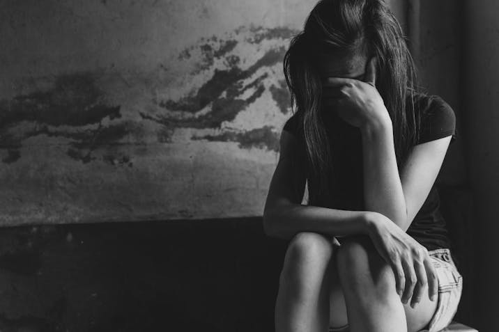 Young depressed woman, domestic and rape violence,beaten and raped sitting in the corner, Domestic violence. Copy space.