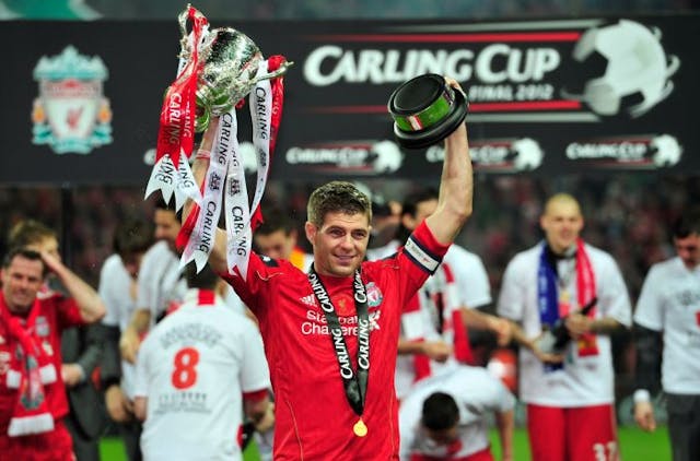 Liverpool’s English footballer Steven Gerrard celebrates with the trophy after his team beat Cardiff City to win the League Cup Final at Wembley Stadium in London, on February 26, 2012. AFP PHOTO/GLYN KIRK RESTRICTED TO EDITORIAL USE. No use with unauthorized audio, video, data, fixture lists, club/league logos or “live” services. Online in-match use limited to 45 images, no video emulation. No use in betting, games or single club/league/player publications. (Photo credit should read GLYN KIRK/AFP via Getty Images)