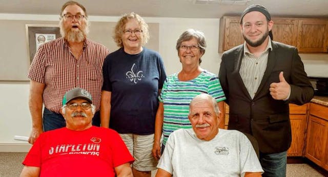 Stapleton residents Brad and Wanda Osnes take a picture with Right To Life of East Texas Director Mark Lee Dickson and members of the Village Board of Stapleton, Nebraska after the historic vote (photo: Mark Lee Dickson)