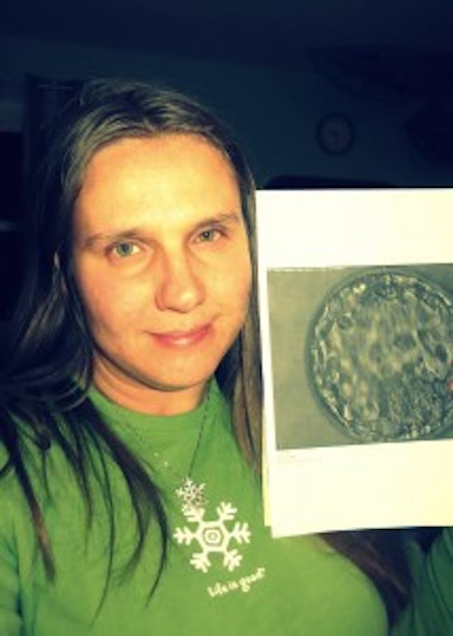 Inga and a photo of her adopted embryo. Inga and a photo of her adopted embryo.