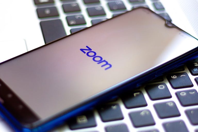 In this photo illustration a Zoom Video Communications logo