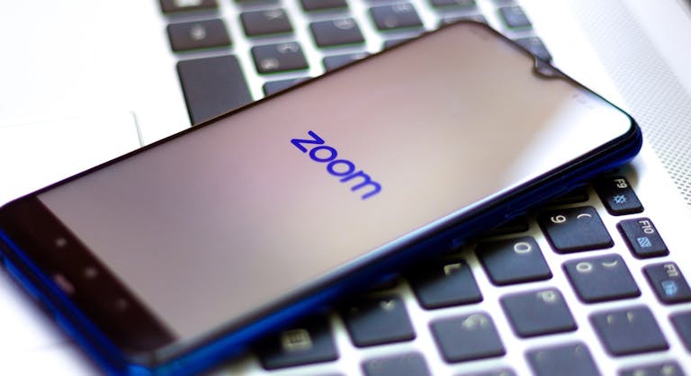 In this photo illustration a Zoom Video Communications logo