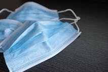 Respiratory mask on desk in office, Protective medical mask with 2019-nCoV, Coronavirus protection concept.