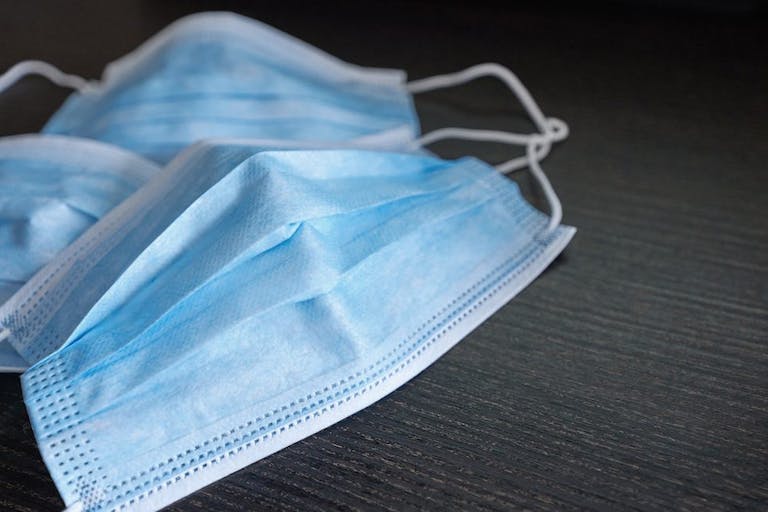 Respiratory mask on desk in office, Protective medical mask with 2019-nCoV, Coronavirus protection concept.