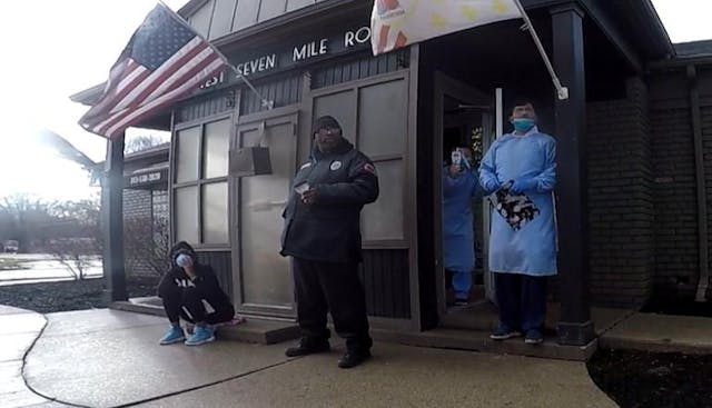 Image: Abortion staffers in full PPE outside abortion clinic in Michigan (Photo credit: Lynn Mills)