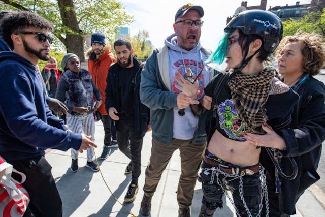 Plainclothes Boston Police officers arrest a pro-choice demonstrator (2nd R) that attacked pro-life speakers (L) from Christ Forgiveness Ministries outside the State House during a Pro-Choice Mother’s Day Rally in Boston, Massachusetts on May 8, 2022. – Multiple US organizations that support abortion rights called for nationwide protests on May 14, after a leaked draft opinion showed the US Supreme Court was poised to overturn its landmark Roe v. Wade decision. (Photo by JOSEPH PREZIOSO / AFP) (Photo by JOSEPH PREZIOSO/AFP via Getty Images) Supreme Court, roe v. Wade, abortion