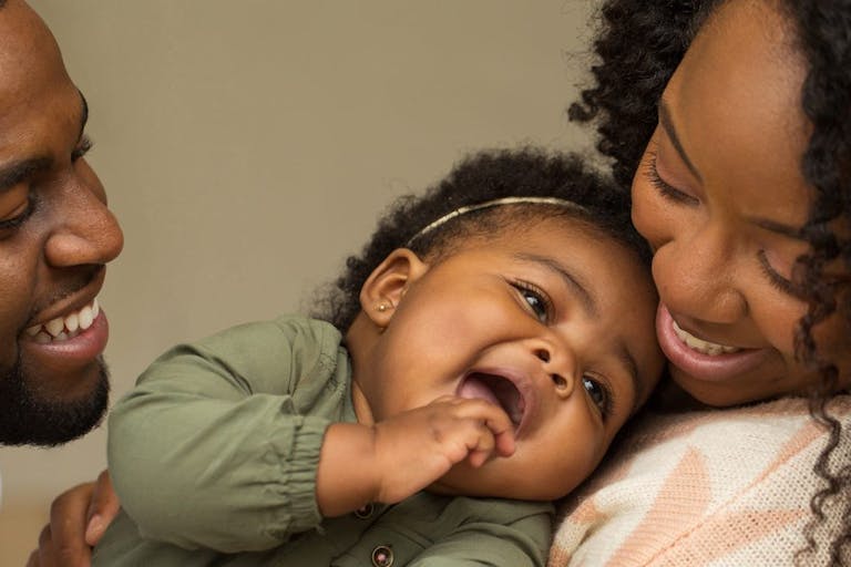 Happy African American family with their little girl.