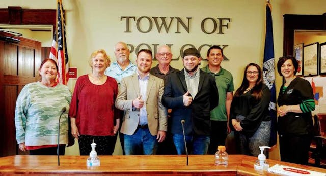 Right To Life of East Texas Director Mark Lee Dickson, First Baptist Church of Pollock Pastor Brian Gunter, and Executive Director of Cenla Pregnancy Center Claire Lemoine take a picture with the Mayor of Pollock and the Town Council after the historic vote (Photo via Mark Lee Dickson)