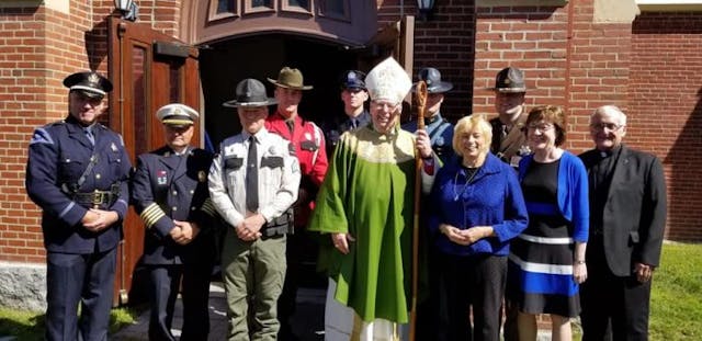 Maine’s Governor Janet Mills (front in black pants) joined people of all faiths for Blue Mass at the Cathedral of the Immaculate Conception in Portland this month to honor law enforcement officers, firefighters, and emergency personnel. Maine facebook