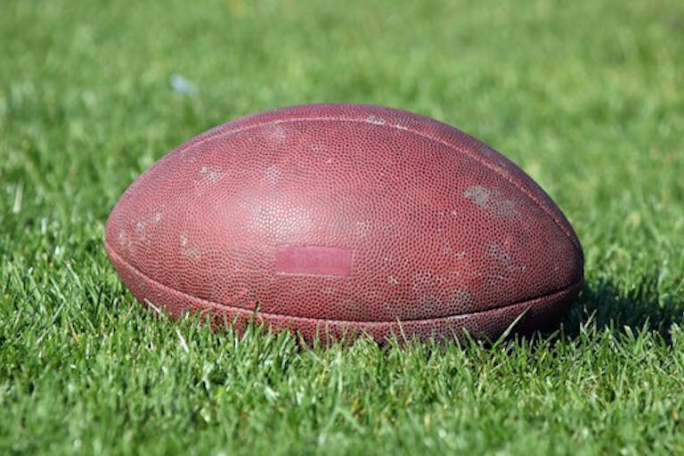 Football in grass. Licensed from Dreamstime.