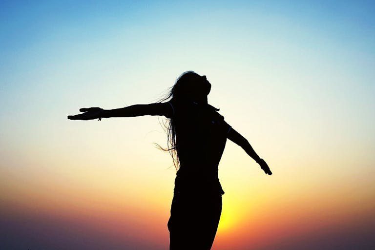 Silhouette Of Woman At Sunset