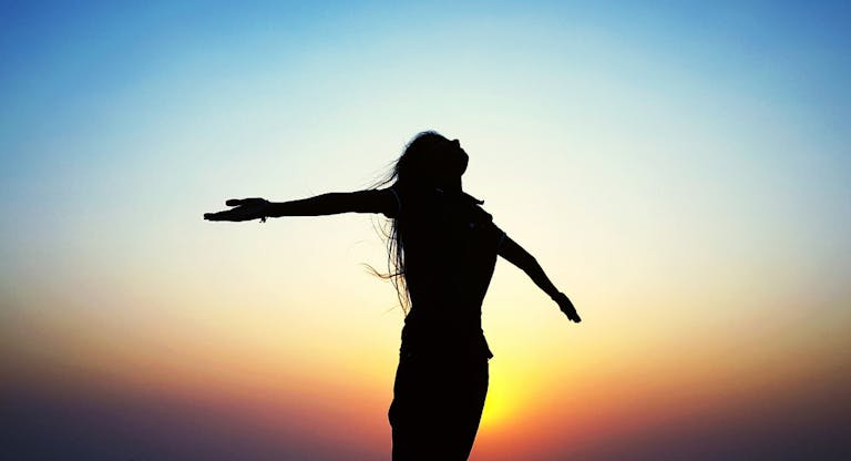 Silhouette Of Woman At Sunset