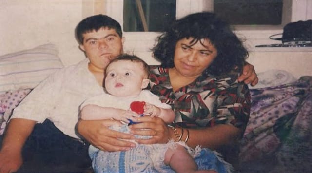 Issa and his parents when he was young. Photo via Facebook. down syndrome