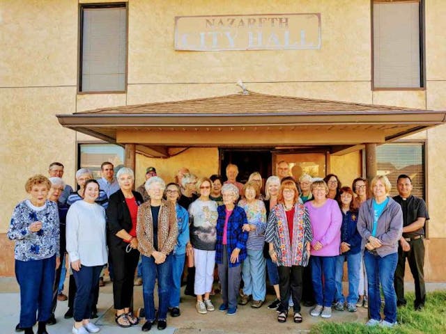Members of the Nazareth community gather together for a picture after the historic vote. (Photo: Mark Lee Dickson)