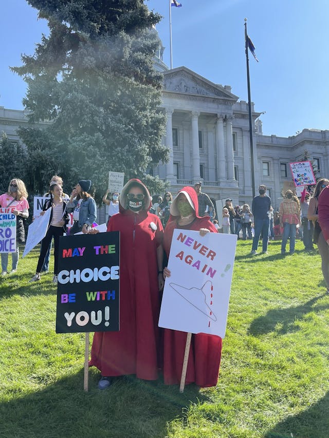 Women’s March Handmaiden holding Coat Hanger (Image: Twitter) Image: Women's March Handmaiden holding Coat Hanger (Image: Twitter)