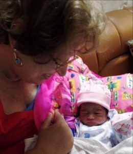 Wilma holds the baby boy she helped save.