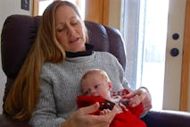 Bette Grande holds her newborn grandson