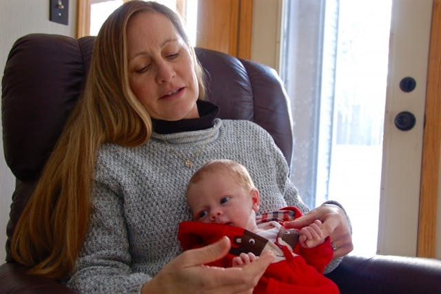 Bette Grande holds her newborn grandson.